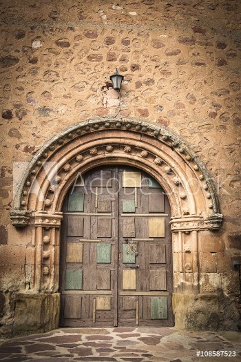 Picture of ancient wooden door on a stone made wall